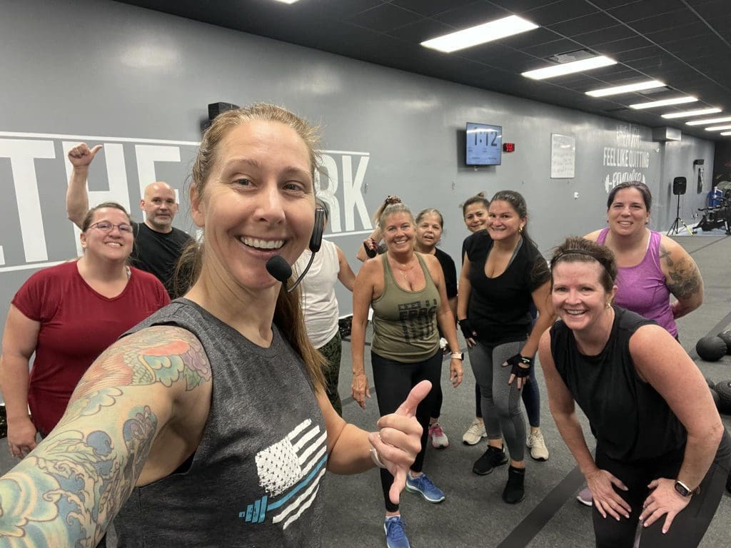 Coastal Fitness Coach posing with members after group fitness session